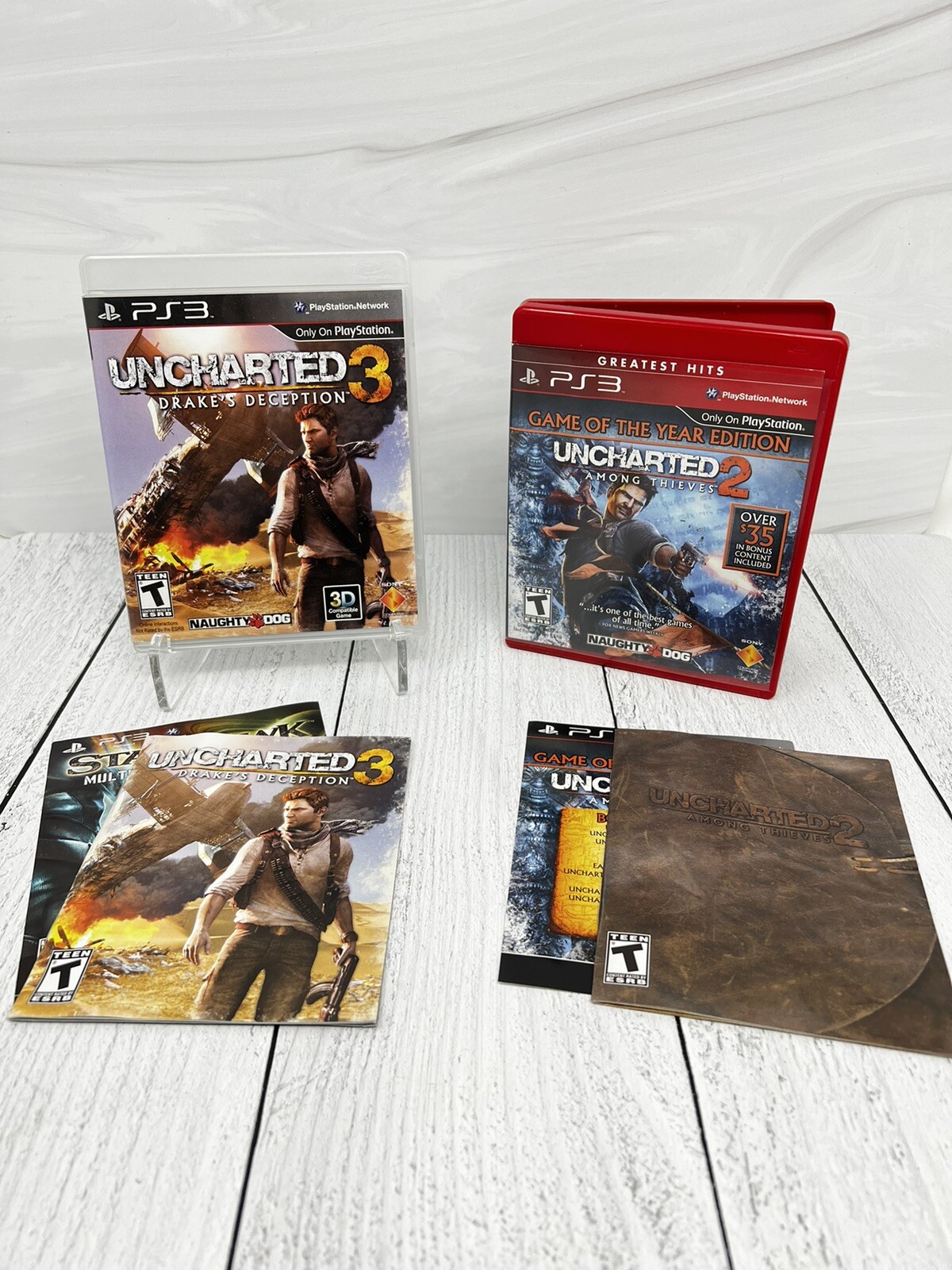 Lot of 2 Uncharted 2 Among Thieves + Uncharted 3 Drakes Deception PS3 Complete